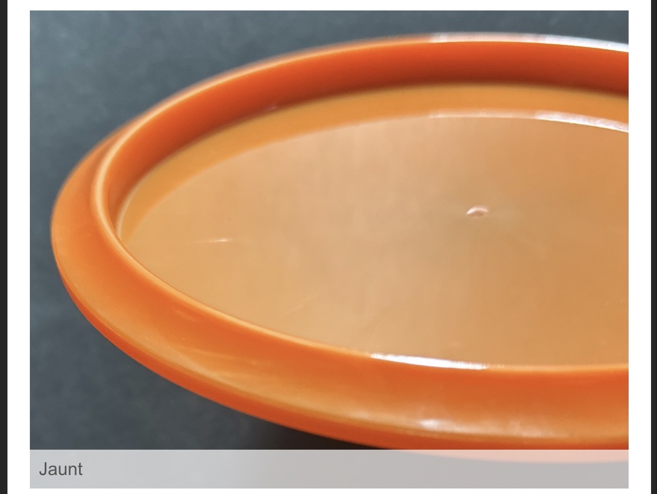 Close view of the underside and rim profile of the orange H13 Jaunt certification sample